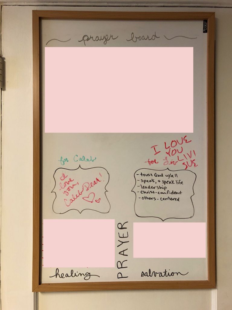 Image of a "before" photo of a marker board with messy prayer requests written in various colors.
